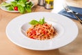 Fresh, cooked Italian spaghetti, pasta with marinara or tomato sauce decorated with basil on the white plate served on the wooden Royalty Free Stock Photo