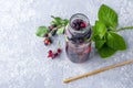 Fresh cool detox drink with Various berries in glass bottle and paper straw. Tasty infused water or lemonade. Proper nutrition and Royalty Free Stock Photo