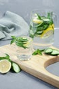 Health care, fitness, healthy food concept. Fresh cool mint lemon cucumber pour water, cocktail, detox drink, lemonade in a glass Royalty Free Stock Photo