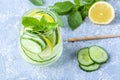 Fresh cool detox water drink with cucumber and lemon. Two glass of Lemonade with basil and mint leaves. Concept of proper Royalty Free Stock Photo