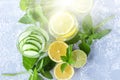 Fresh cool detox water drink with cucumber and lemon. Two glass of Lemonade with basil and mint leaves. Concept of proper Royalty Free Stock Photo