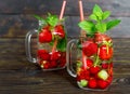 Fresh cool drink of ripe juicy cherry, strawberry, currant and gooseberry berries Royalty Free Stock Photo