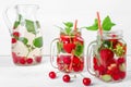 Fresh cool drink of ripe juicy cherry, strawberry, currant and gooseberry berries Royalty Free Stock Photo