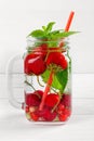 Fresh cool drink of ripe juicy cherry, strawberry, currant and gooseberry berries Royalty Free Stock Photo