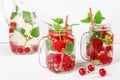 Fresh cool drink of ripe juicy cherry, strawberry, currant and gooseberry berries Royalty Free Stock Photo