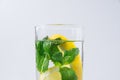 Fresh Cool Infused Detox Water with Ripe Organic Sliced Lemons Mint in Tall Glass. White Background. Healthy Drink Royalty Free Stock Photo