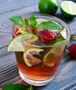 Fresh cool strawberry mojito in a glass on a wooden table