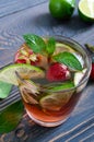 Fresh cool strawberry mojito in a glass on a wooden table