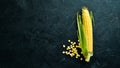 Fresh corn on a black background. Vegetables.