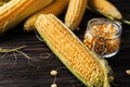 Fresh corn cob and jar with kernels on table Royalty Free Stock Photo