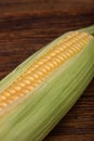 Fresh corn cob maize on the wooden table, top view closeup Royalty Free Stock Photo