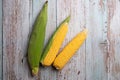 Fresh corn cobs on flat wooden background Royalty Free Stock Photo