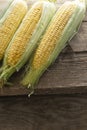 Fresh Corn on Cobs on old wooden table  top view  closeup Royalty Free Stock Photo