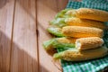 Fresh corn on cobs on rustic wooden table, closeup Royalty Free Stock Photo