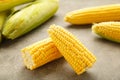 Fresh corn on cobs on rustic wooden table, closeup. Ripe corn. Half of broken open sweet corn Royalty Free Stock Photo