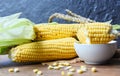 Fresh corn on cobs and sweet corn ears on rustic wooden table background Royalty Free Stock Photo