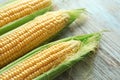 Fresh corn cobs on wooden background, closeup Royalty Free Stock Photo