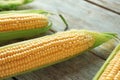 Fresh corn cobs on wooden background, closeup Royalty Free Stock Photo