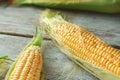 Fresh corn cobs on wooden background, closeup Royalty Free Stock Photo