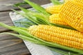 Fresh corn cobs on wooden background, closeup Royalty Free Stock Photo