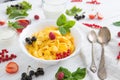 Fresh corn flakes with strawberries and milk close up Healthy tasty breakfast cornflakes with strawberries, raspberries Royalty Free Stock Photo