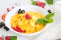 Fresh corn flakes with strawberries and milk close up Healthy tasty breakfast cornflakes with strawberries, raspberries Royalty Free Stock Photo