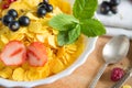 Fresh corn flakes with strawberries and milk close up Healthy tasty breakfast cornflakes with strawberries, raspberries Royalty Free Stock Photo