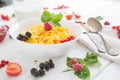 Fresh corn flakes with strawberries and milk close up Healthy tasty breakfast cornflakes with strawberries, raspberries Royalty Free Stock Photo