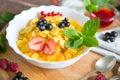 Fresh corn flakes with strawberries and milk close up Healthy tasty breakfast cornflakes with strawberries, raspberries