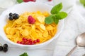 Fresh corn flakes with strawberries and milk close up Healthy tasty breakfast cornflakes with strawberries, raspberries