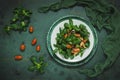 Fresh corn salad with mushrooms and roasted seeds on a white plate on green background Royalty Free Stock Photo