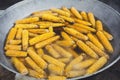 Fresh corncobs cooked in metal cauldron pot