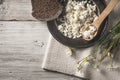 Fresh cottage cheese with bread and flowers on the white wooden table top view Royalty Free Stock Photo