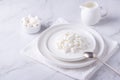 Fresh cottage cheese grain in a white bowl and marshmallows. Royalty Free Stock Photo