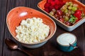 Fresh cottage cheese with juicy berries raspberries, strawberry and grapes on dark wooden background. Royalty Free Stock Photo