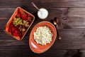 Fresh cottage cheese with juicy berries raspberries, strawberry and grapes on dark wooden background. Royalty Free Stock Photo