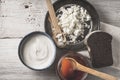 Fresh cottage cheese with sour cream, jam and bread on the white wooden table top view Royalty Free Stock Photo