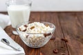 Fresh cottage cheese in a transparent bowl with raisins. In the background is a glass of kefir. Fermented foods. Good bacteria for