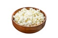 Fresh Cottage cheese in a wooden bowl. Isolated on white background. Top view. Royalty Free Stock Photo