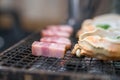 Fresh crab and pork are grilled on mini strove, in local Japanese restaurant Royalty Free Stock Photo