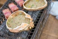 Fresh crab and pork are grilled on mini strove, in local Japanese restaurant Royalty Free Stock Photo