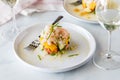 Fresh Crab and shrimp stack salads with vinaigrette and garnished with chives.