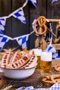 Fresh craft beer. German sausages on the grill. Traditional German sausages and pastry brezel for a beer festival. Wood