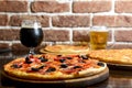 Fresh craft beer and pizza with vegetables and meat. Party concept, different kinds of pizza with delicious craft beer Royalty Free Stock Photo