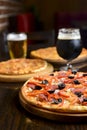 Fresh craft beer and pizza with vegetables and meat. Party concept, different kinds of pizza with delicious craft beer Royalty Free Stock Photo