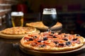 Fresh craft beer and pizza with vegetables and meat. Party concept, different kinds of pizza with delicious craft beer Royalty Free Stock Photo