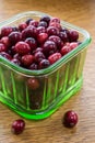 Fresh cranberries in a green glass bowl