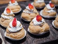 Fresh cream puffs filled with whipped cream and strawberry on top. Royalty Free Stock Photo