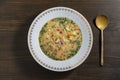 Fresh creamy salmon fish soup with potatoes, carrots, broccoli, peppers and onions in a ceramic plate on a wooden table. A Royalty Free Stock Photo