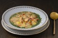 Fresh creamy salmon fish soup with potatoes, carrots, broccoli, peppers and onions in a ceramic plate on a wooden table, closeup. Royalty Free Stock Photo